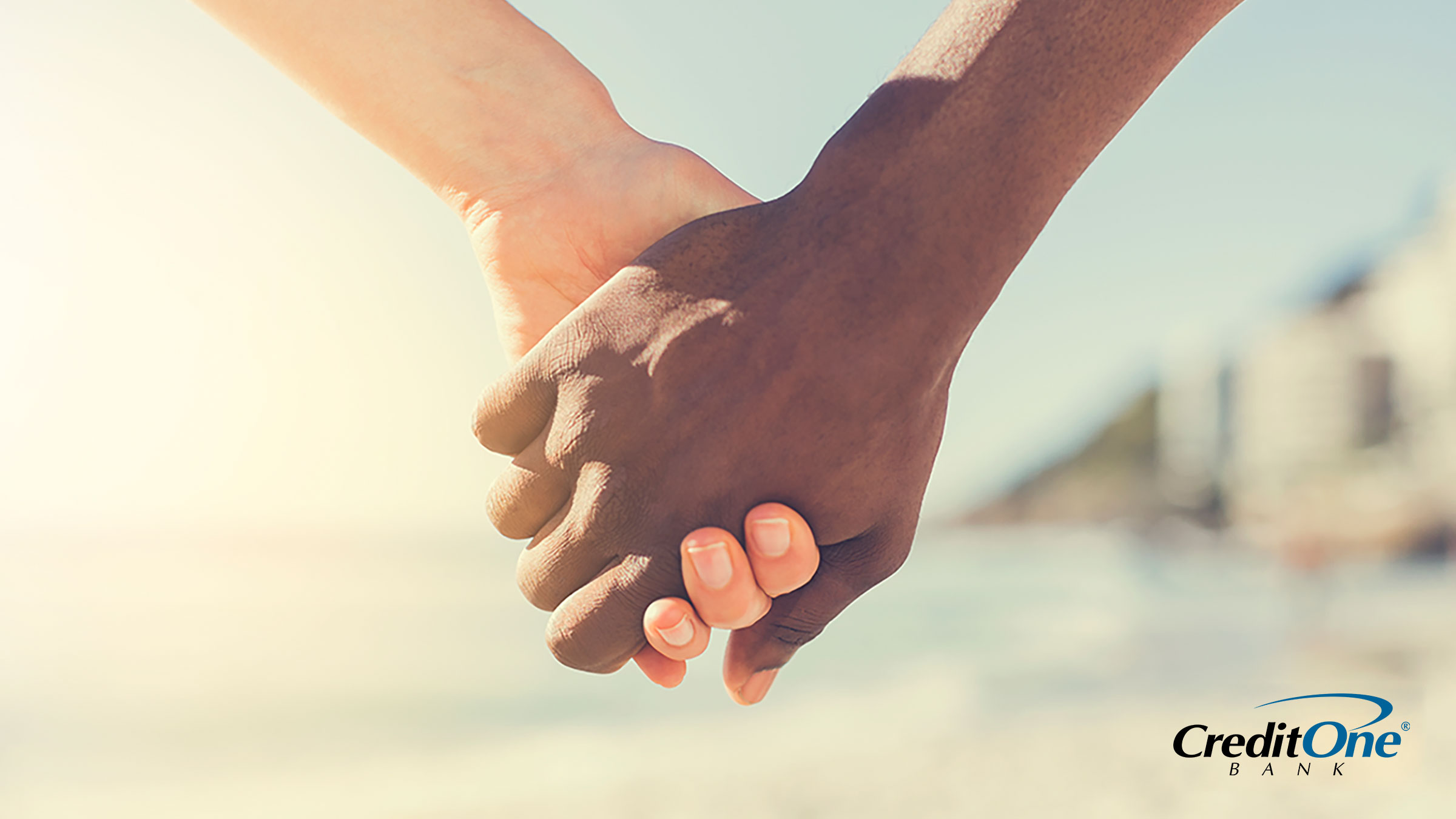 Two people holding hands demonstrating how income and credit come together