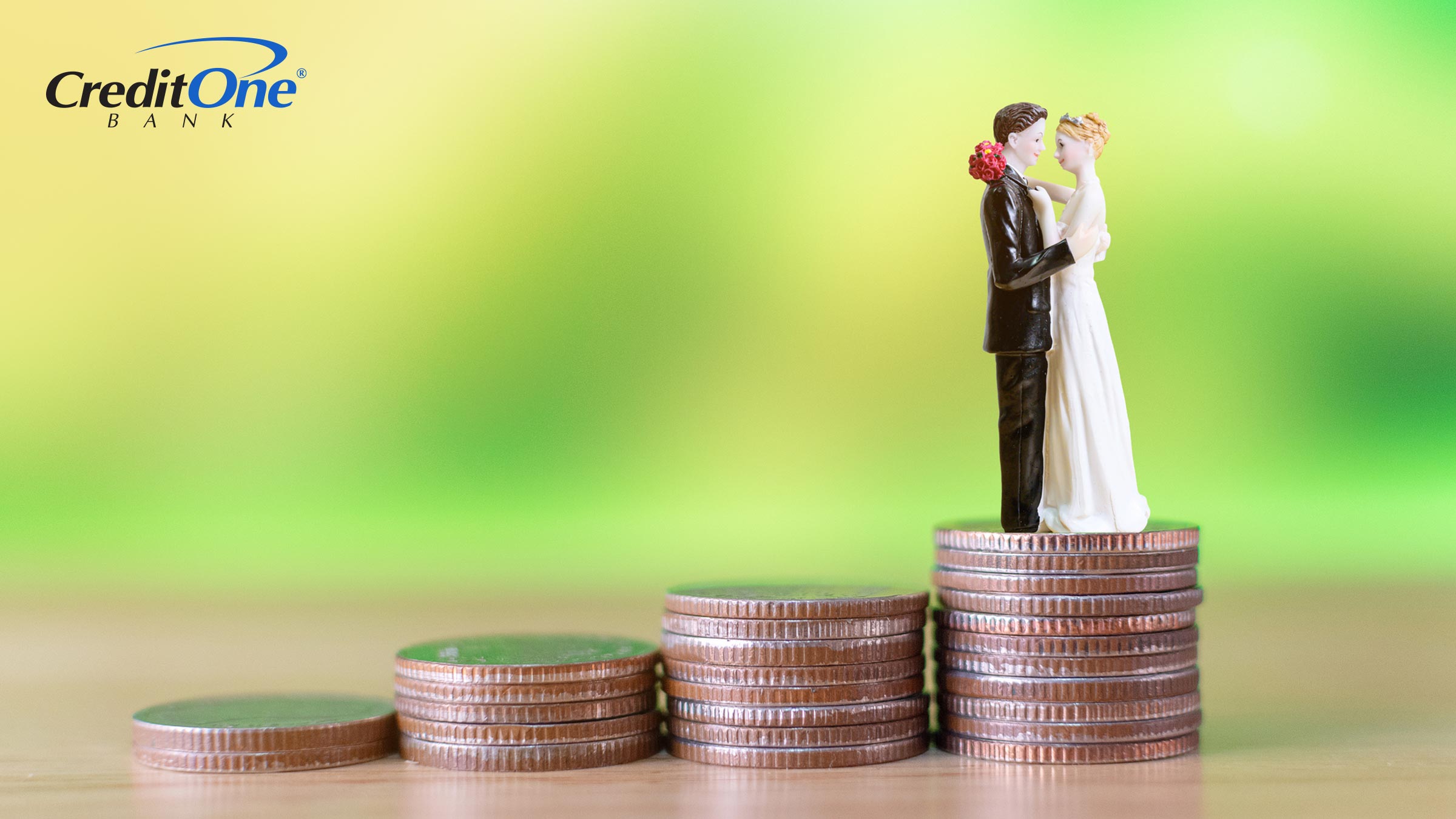 A bride and groom cake topper stands on the highest of several stacks of coins, representing the rising costs of weddings.