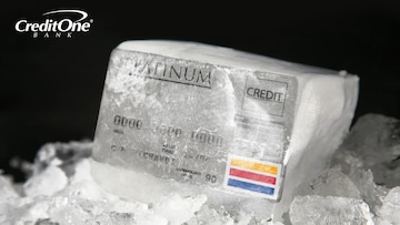 A credit card is frozen in a block of ice, representing the concept of freezing your credit.