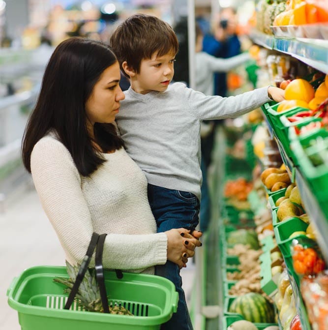 Mother and child grocery shopping