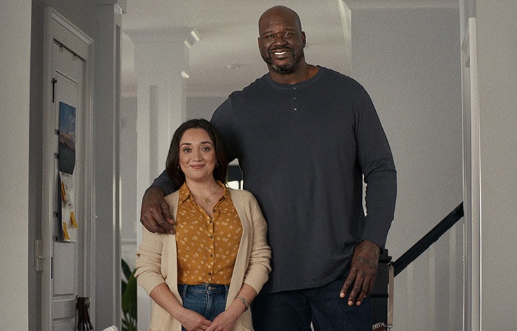 Shaq and a housewife standing together in her living room
